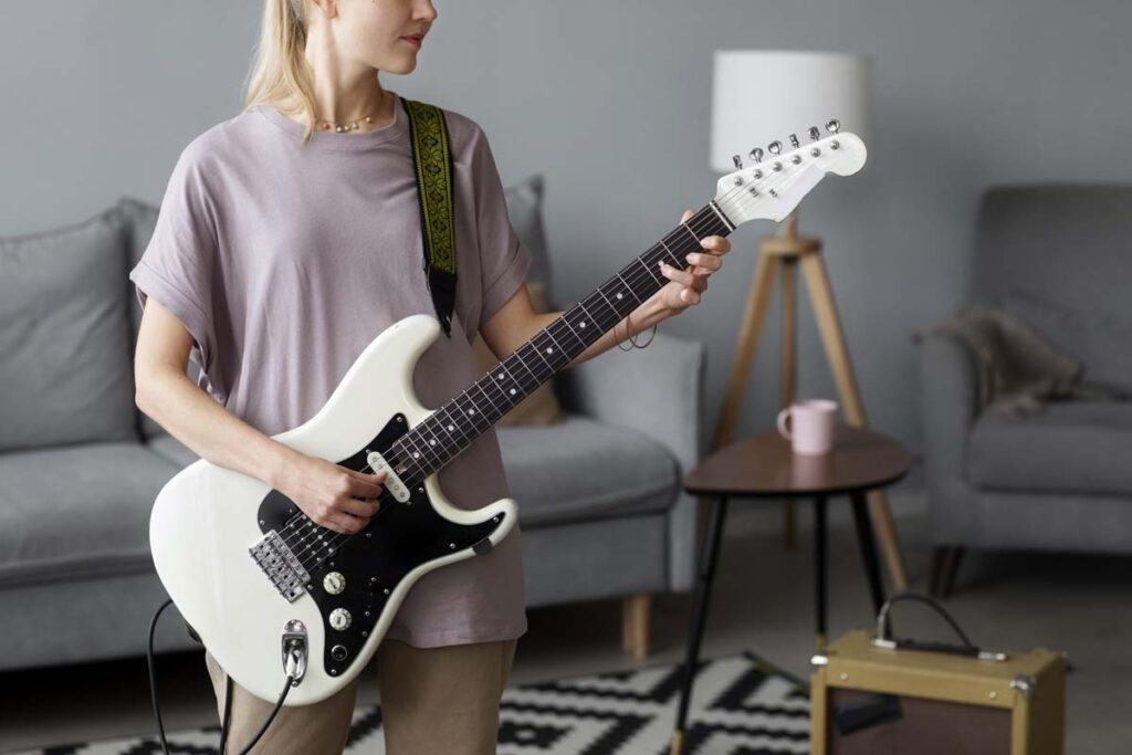 teenager playing electric guitar